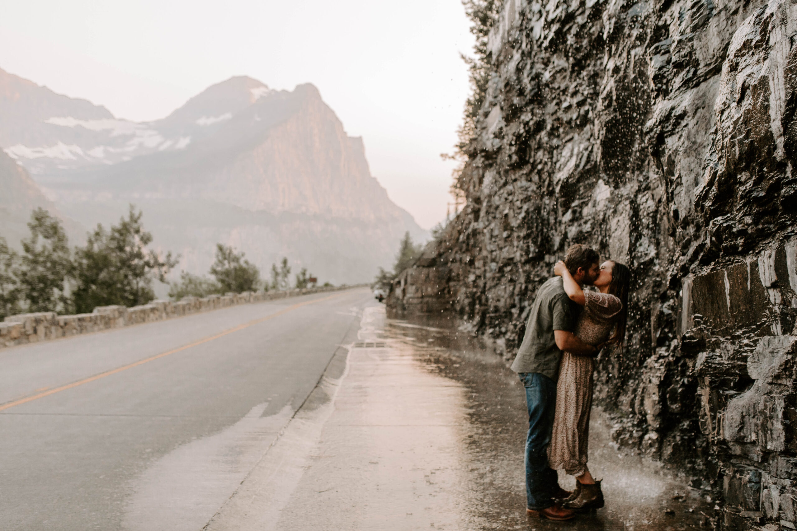 Glacier National Park Weeping Wall, Couple Kisses in the rain for adventurous couples photo session
