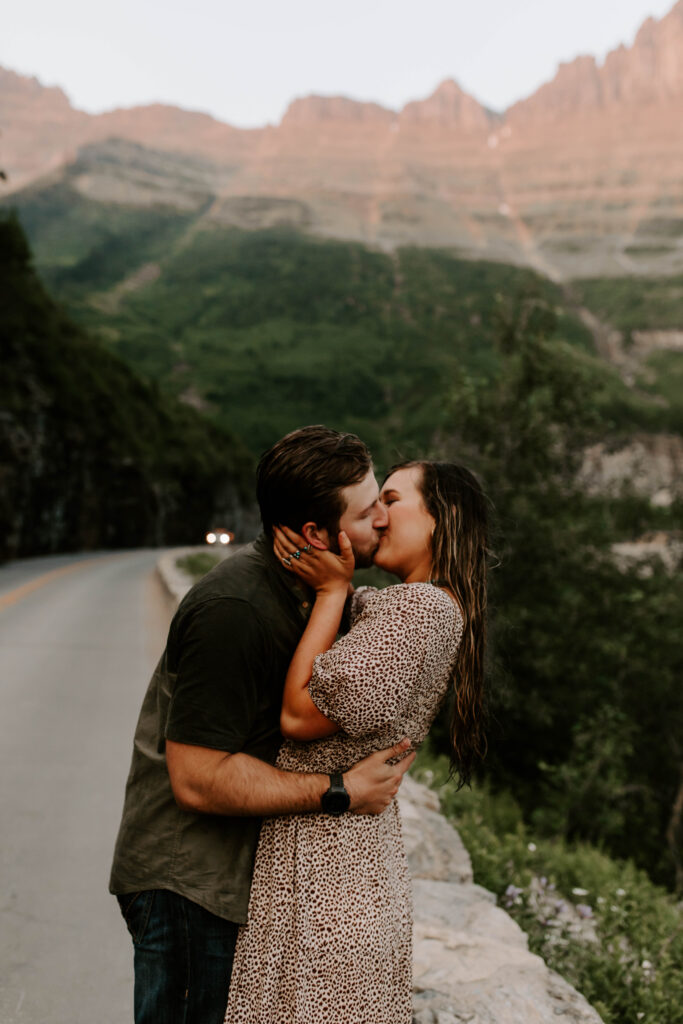 Couple kisses on going to the sun road during adventurous couple's session