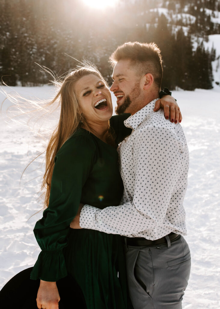 couple laughs during engagement photos
