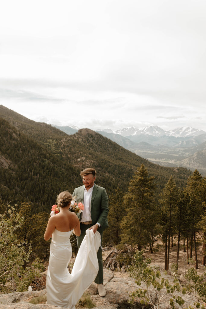 bride and groom walk around in the mountains together