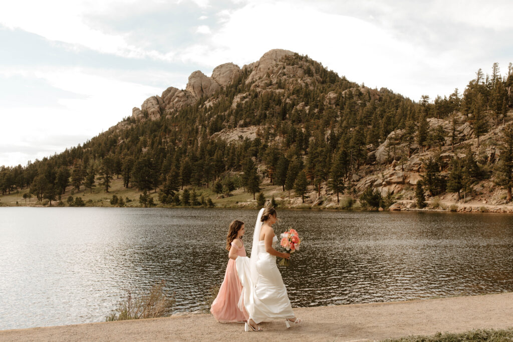 girl carries brides dress