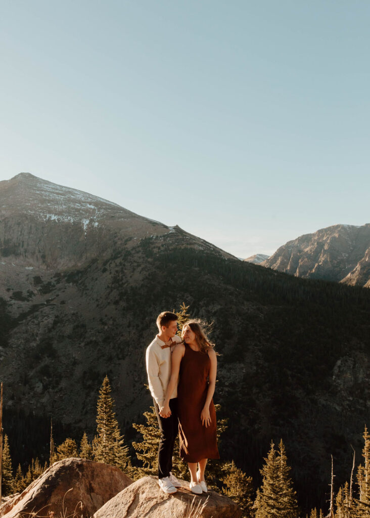 smiling at each other on top of mountain