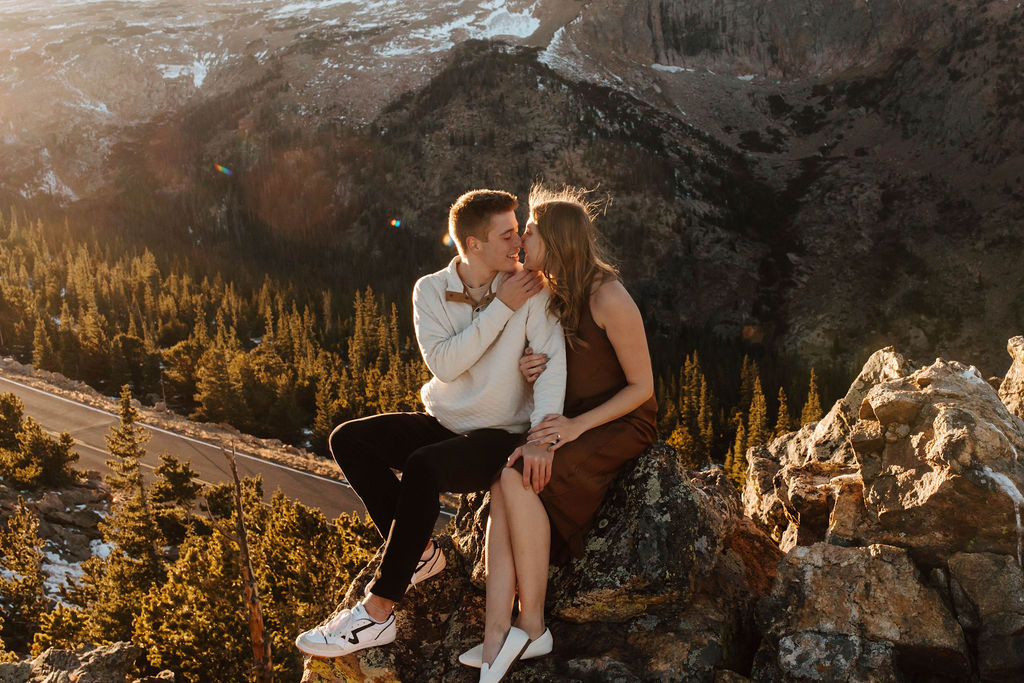 couple kisses on rock above trail ridge road