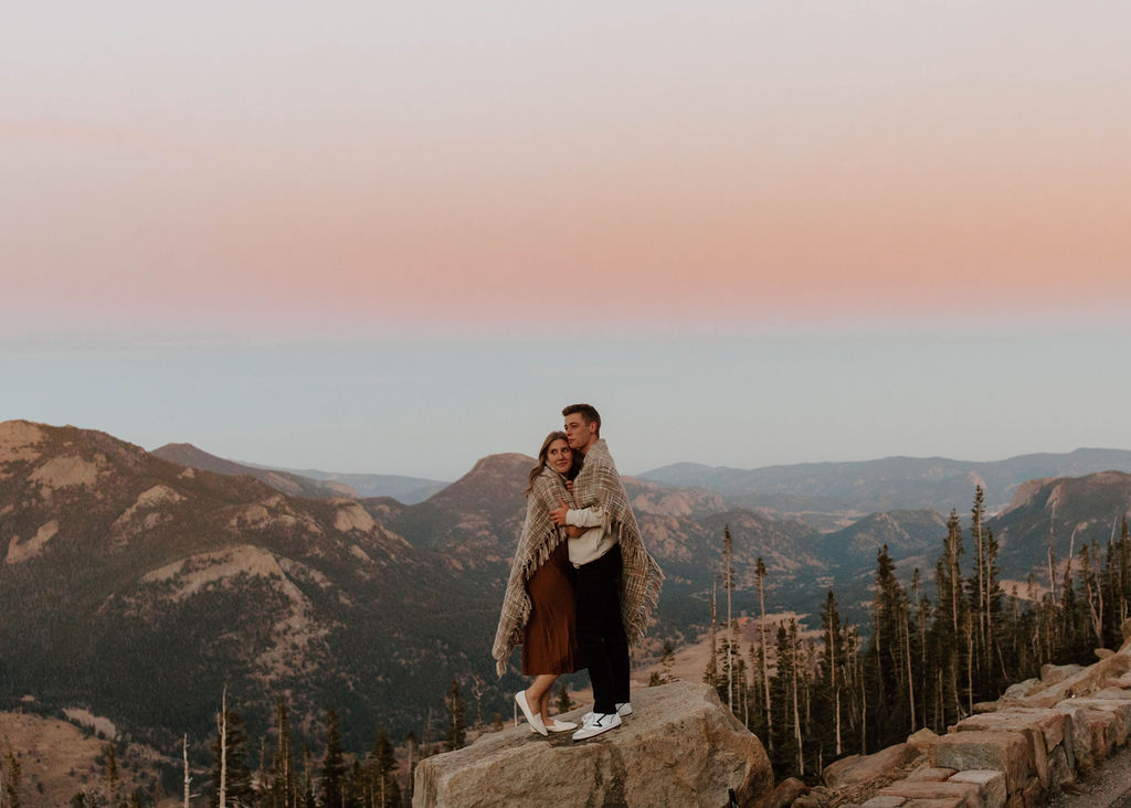 couple is enveloped by pink skies