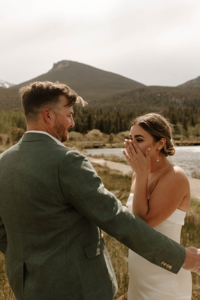 bride cries happy tears, and groom reaches out to hug her