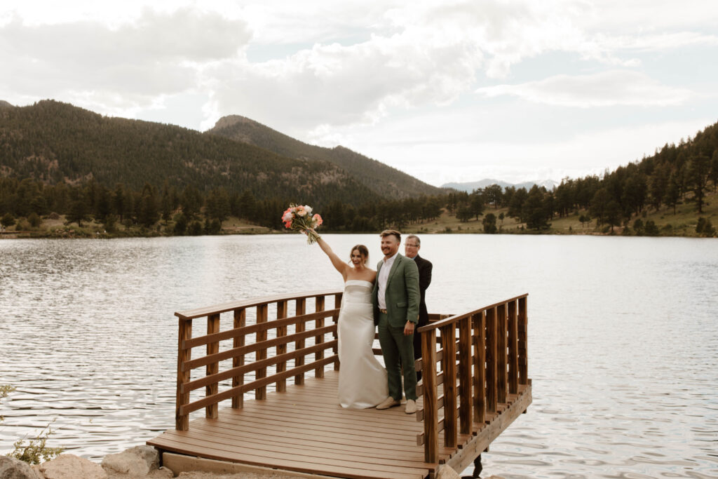 bride and groom cheer and face their family as newlyweds