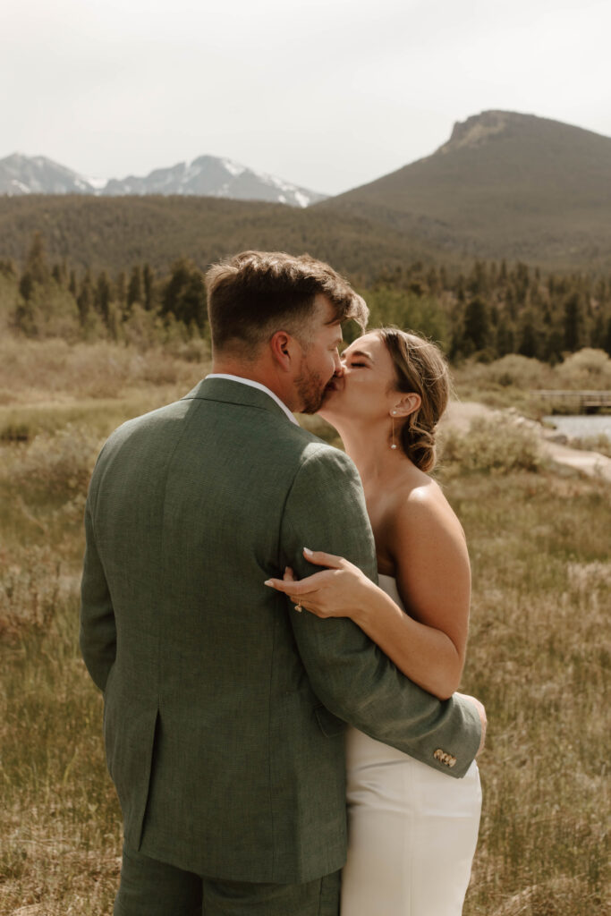 bride and groom kiss after exchanging vows
