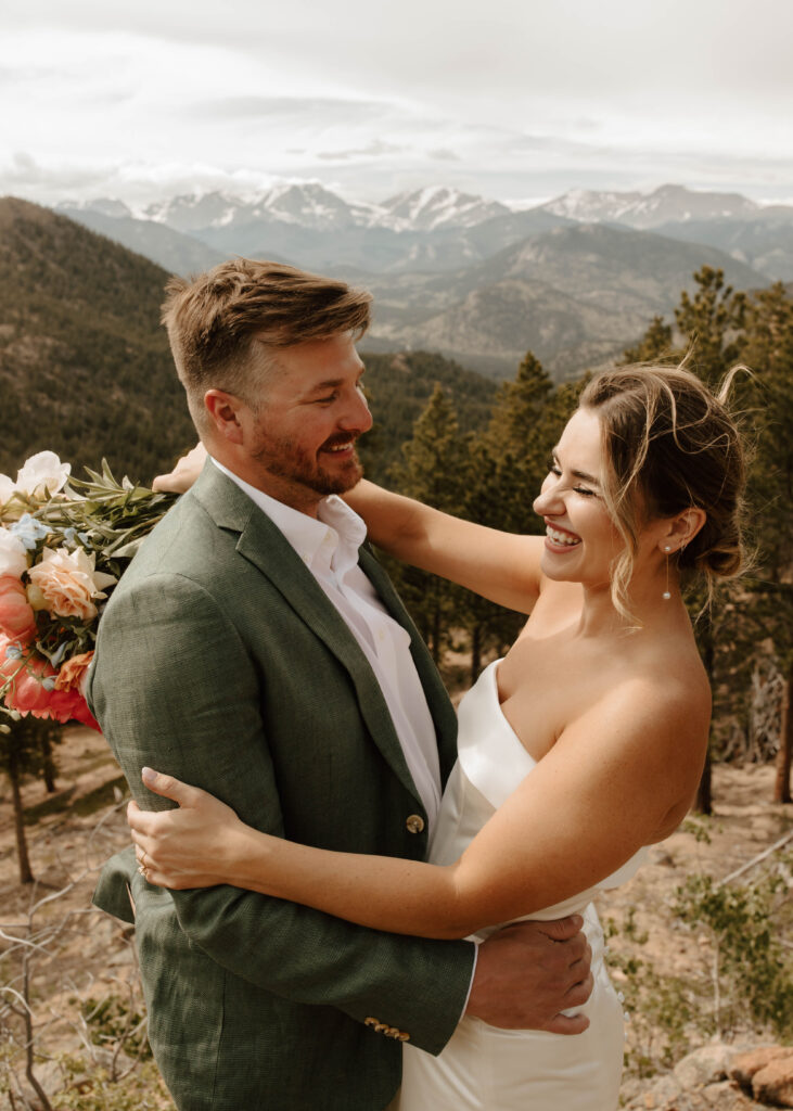 bride and groom embrace and laugh