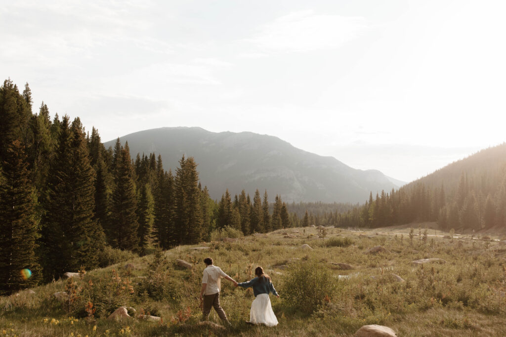 couple walks through meadow