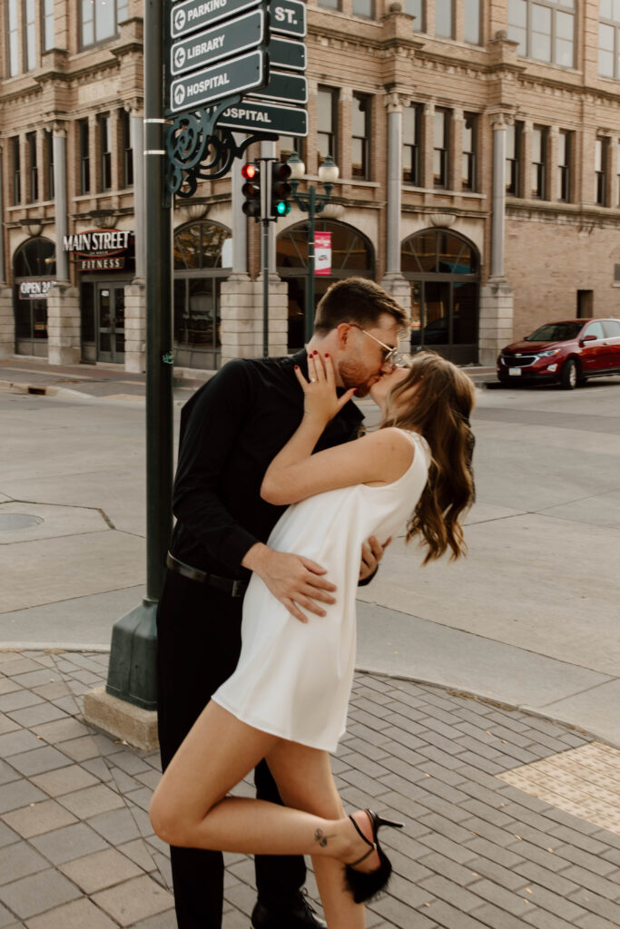 couple dips and kisses on street corner