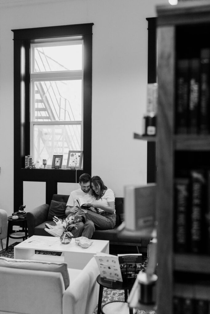 couple reads a book together in a book store