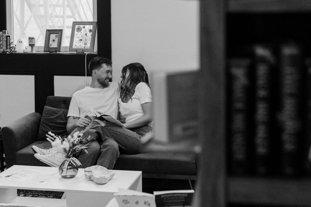 laughing while reading a book in the bookstore