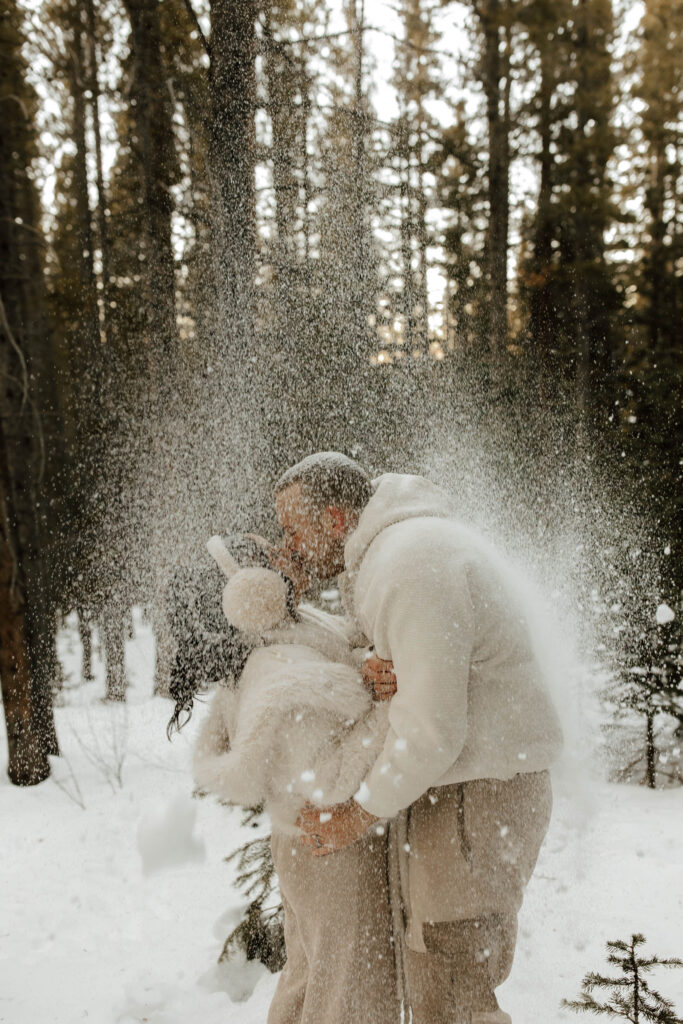 throwing snow in the air and kissing