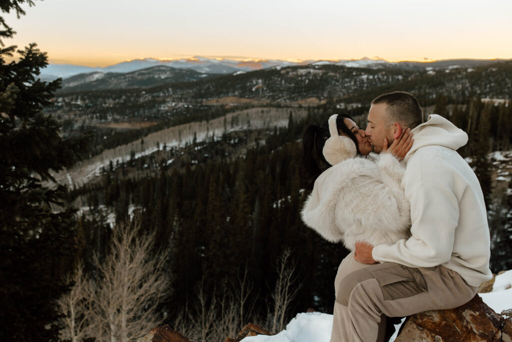 kissing in the snow covered mountains