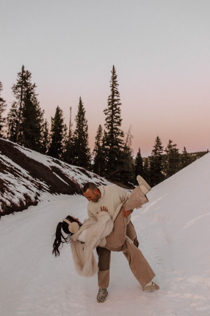 dip and kiss in the snow, fun engagement photo ideas