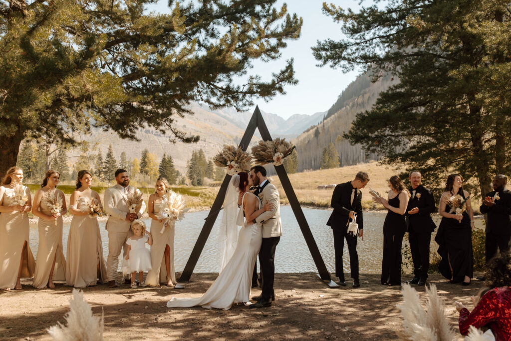 couple kisses during intimate vail wedding ceremony