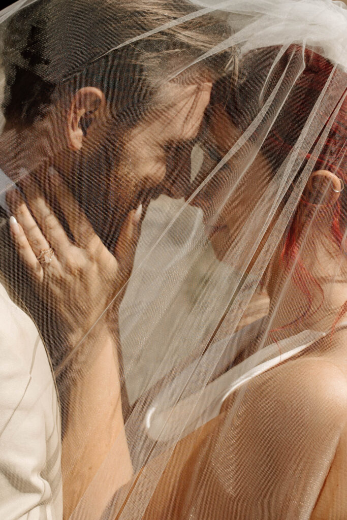 couple takes wedding portraits under the veil