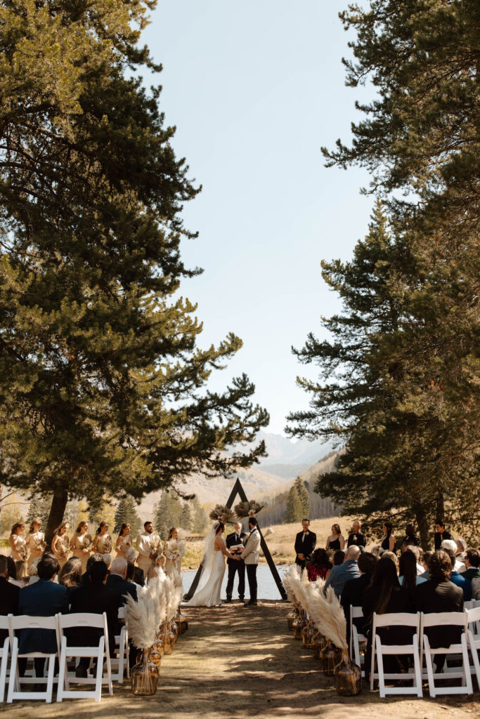 couple stands at altar during vail colorado micro wedding on wedding island in the mountains