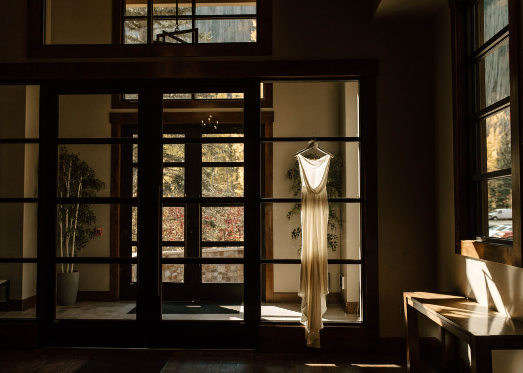 bride's dress hangs from door at vail golf club