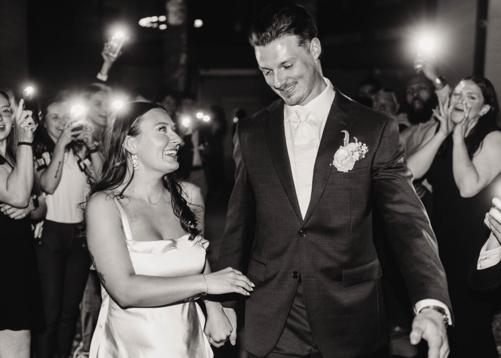 bride and groom exit wedding reception in castle rock colorado