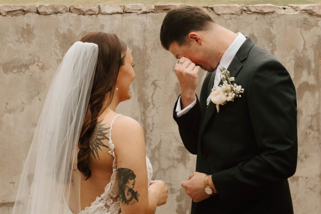 bride and groom crying during photos