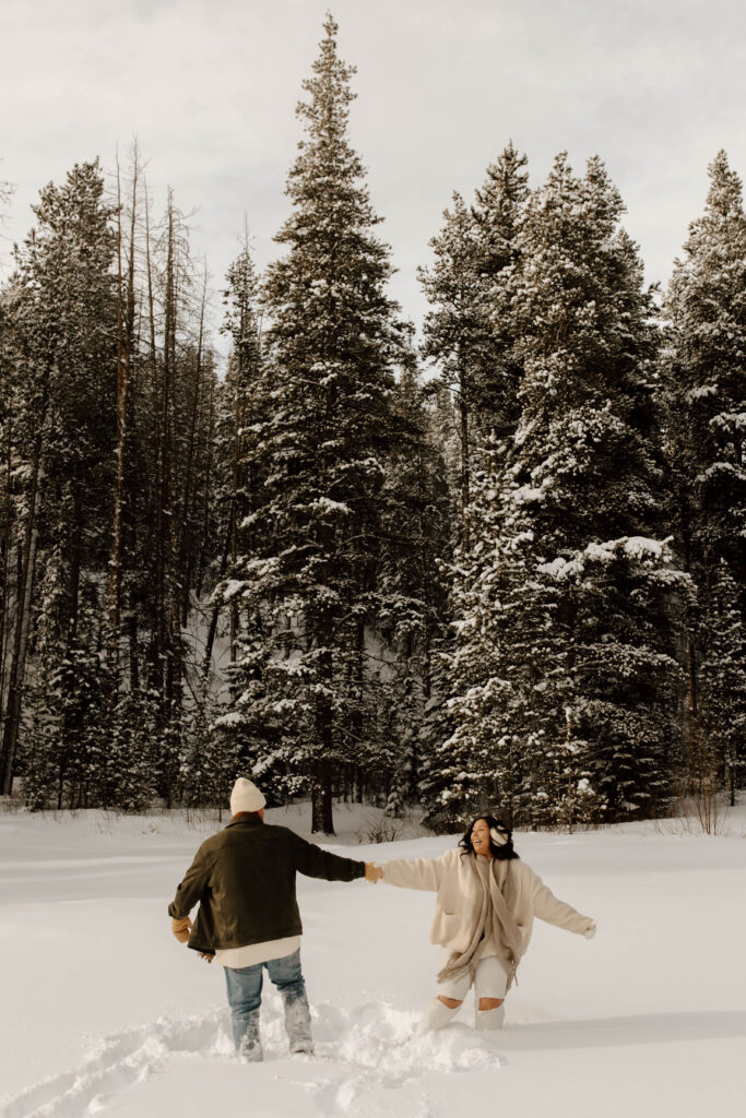 playing in the snow during colorado adventure engagement sessions