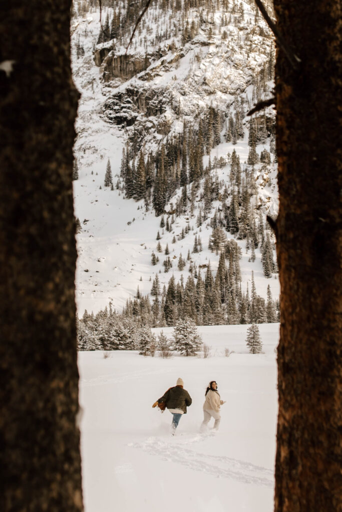 playing in the snow during adventure colorado engagement photos 